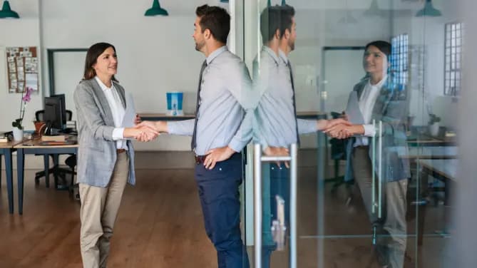 business analyst shaking hands with interviewer