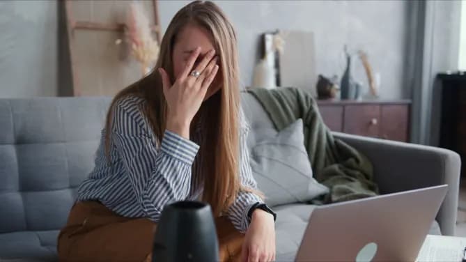 woman stressed in front of her laptop