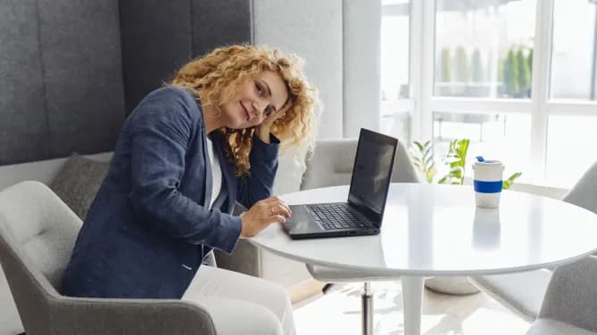 woman with laptop looking sideways