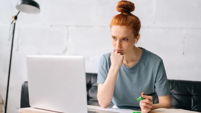 woman concerned looking at computer