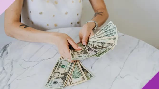 Woman counting money, illustrating essential financial tips for women