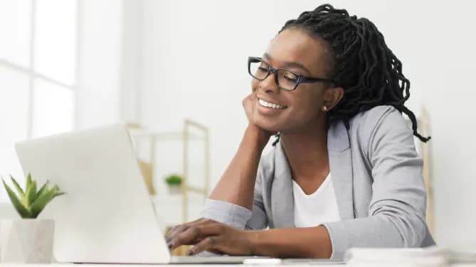 Woman at computer works on her business plan
