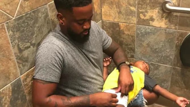 Donte Palmer Changing Son's Diaper