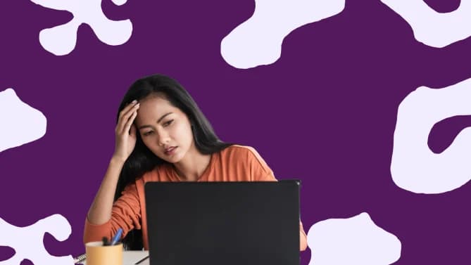 woman at a desktop computer looking stressed