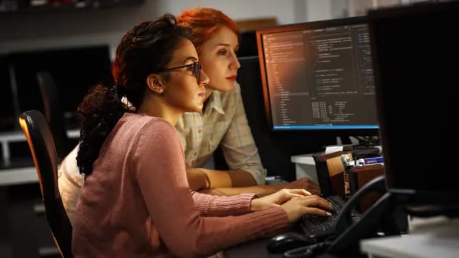 Two women on computers