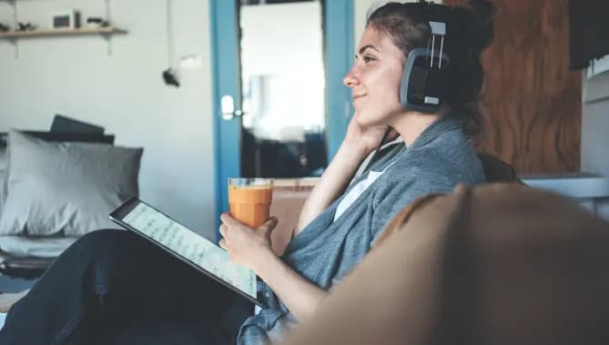 Woman on tablet with headphones