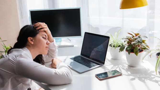 woman tired looking at computer