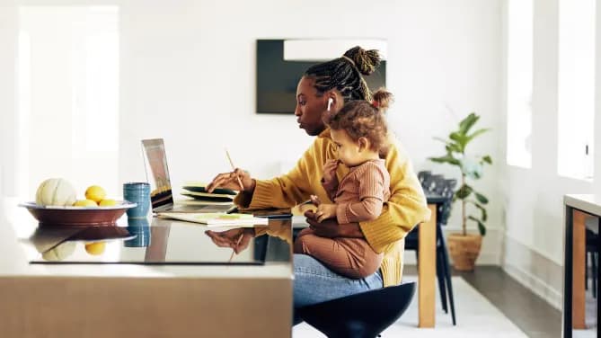 woman sitting with child working from home