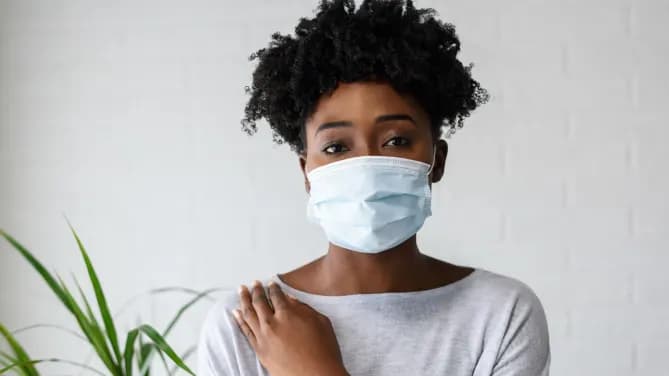 Woman wearing health mask at work