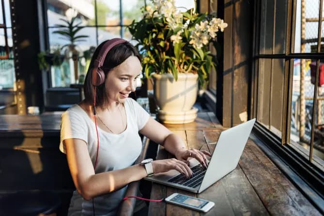Woman smiles in front of a laptop