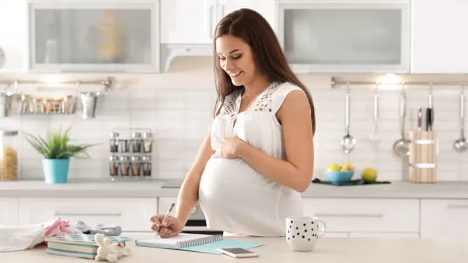 Pregnant woman writing