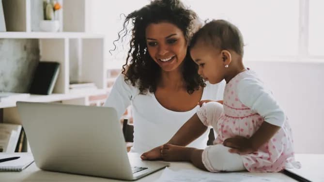 Woman and baby on laptop