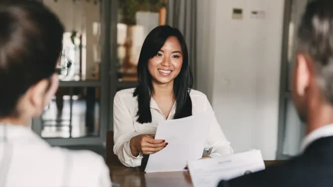 woman holding a resume in an interview
