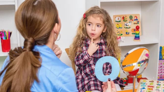 speech pathologist working with a child
