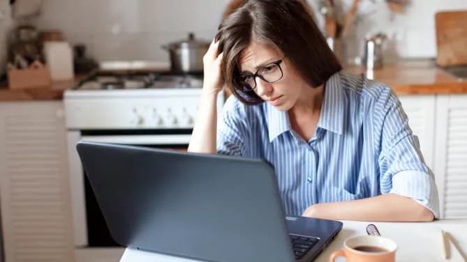 Stressed woman at laptop