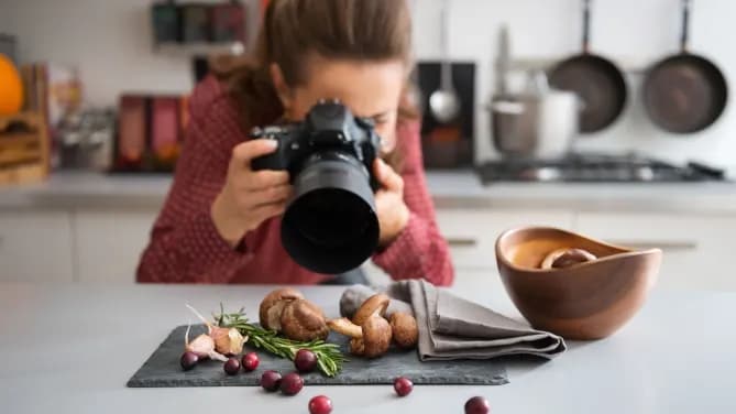 woman photographing mushrooms at home with professional camera
