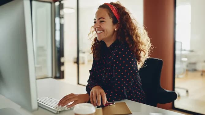 Woman smiling at her desk