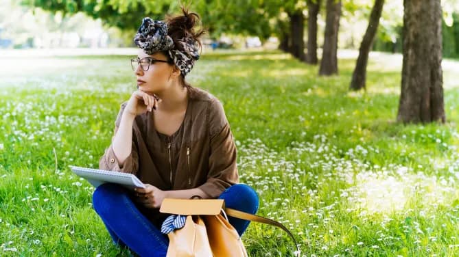 woman journaling on a lawn
