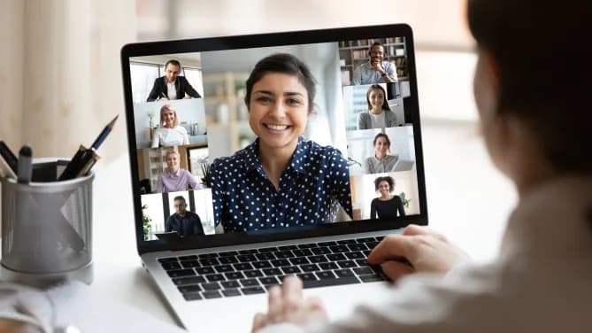 Laptop screen showing video chat with nine coworkers.