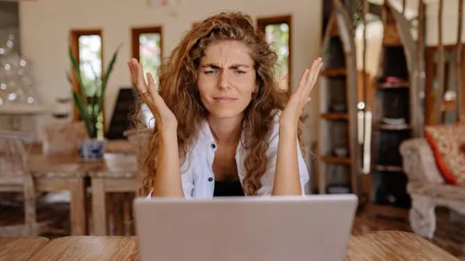 woman staring at her laptop frustrated