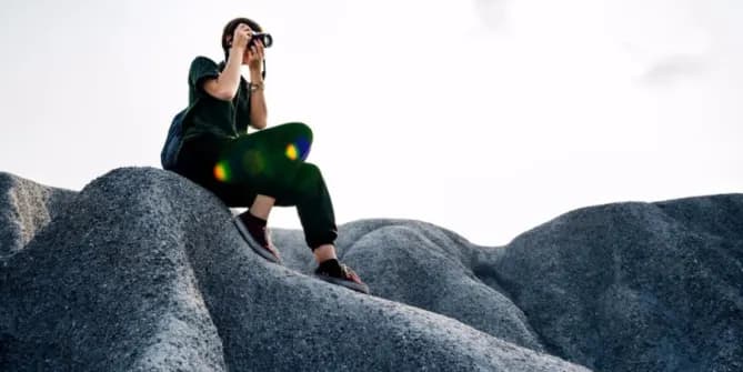 Woman taking photo on rock