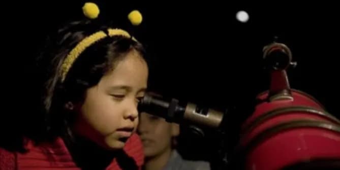 Girl looking in telescope