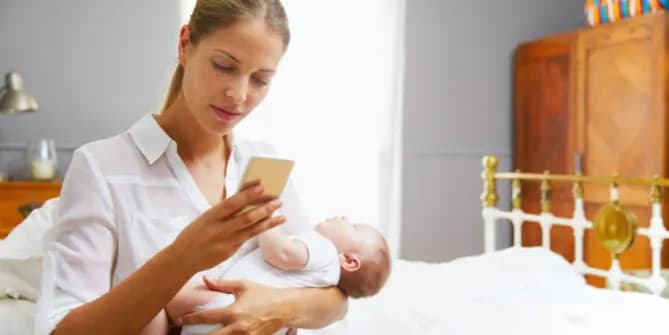 Mom holding baby and cell phone