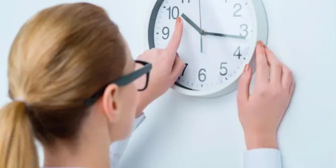 Woman fiddling with clock