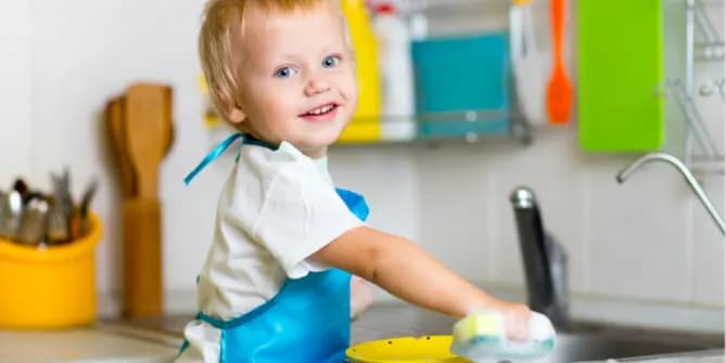 A young boy helps in the kitchen