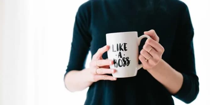 woman holding "like a boss" mug